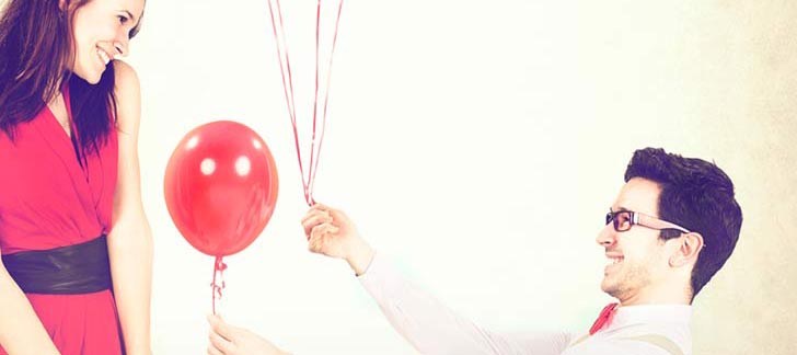 man giving woman a balloon