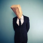 sad and ashamed businessman with bag over head