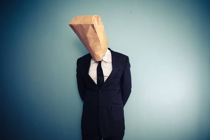 sad and ashamed businessman with bag over head